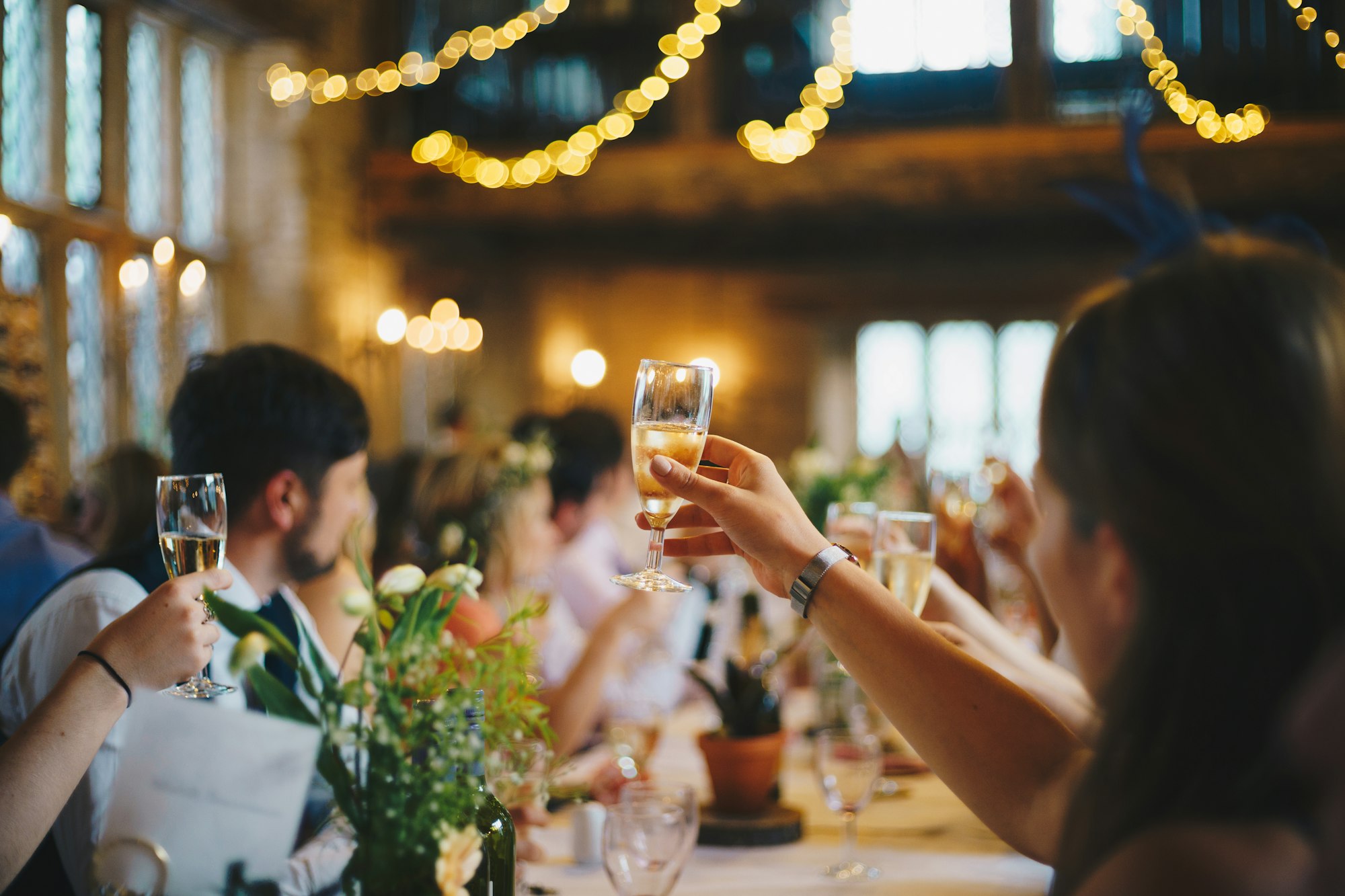 Gasten heffen het glas in een sfeervol verlicht restaurant